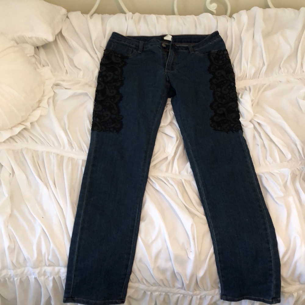 Dark wash jeans with lace detail on upper thigh